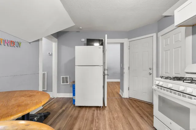 a kitchen with a refrigerator and a stove top oven