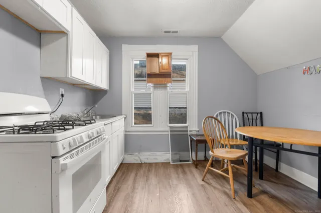 a kitchen with a stove a sink and a refrigerator