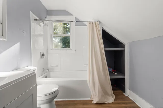 a bathroom with a tub and window