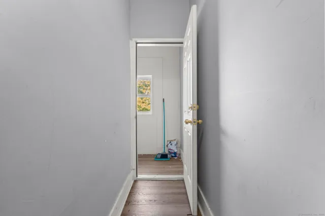a view of a hallway with wooden floor