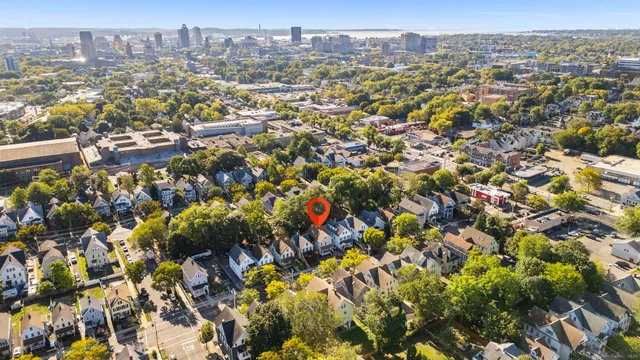 an aerial view of residential houses with city view