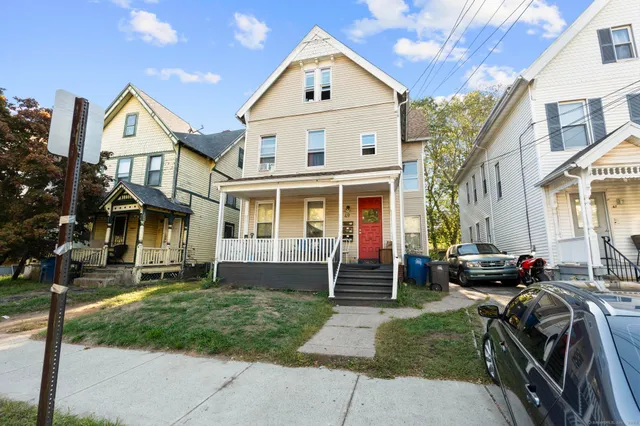 a front view of a residential apartment building with a yard