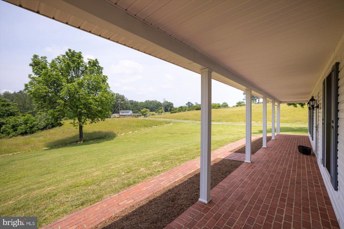 274 A Aaron Mountain Road Castleton, VA 22716 - Photo 33 of 76 Serene porch view over lush green fields.