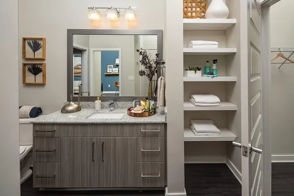 a bathroom with a granite countertop sink and a mirror