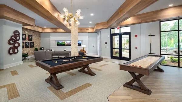 a living room with a piano table and a large window
