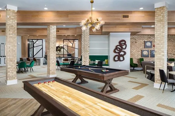 a living room with fireplace furniture and a chandelier