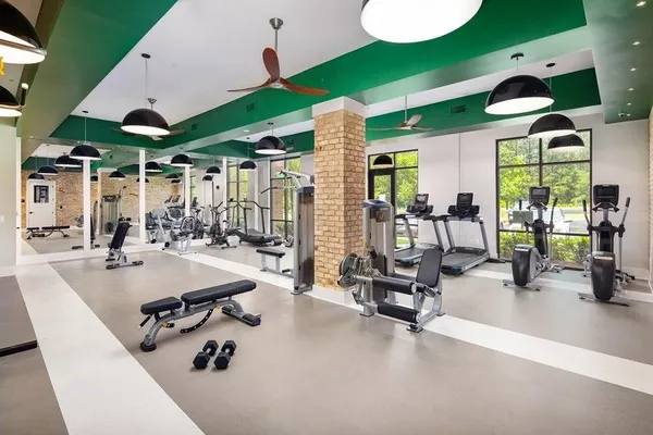 a view of a patio with dining table and chairs under an umbrella
