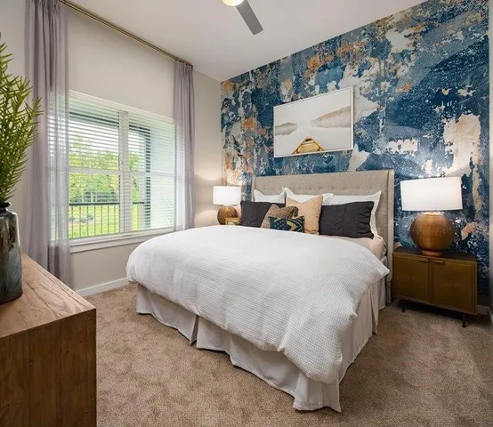 a bed sitting in a bedroom next to a window