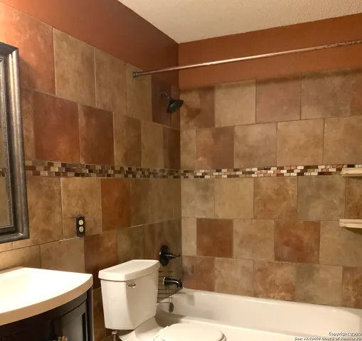 a bathroom with a toilet a sink and shower