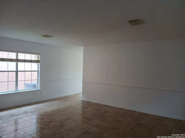 an empty room with a empty space and window