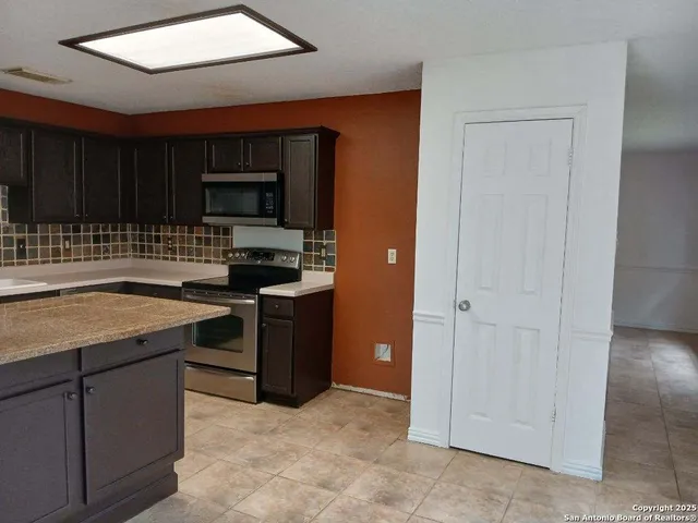 a kitchen with a sink and a stove top oven