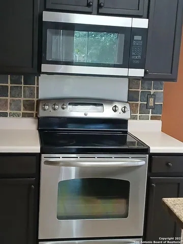 a stove top oven sitting inside of a kitchen