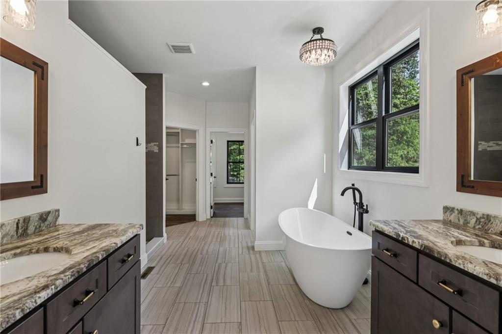 1565 Neville Road Beaver, PA 15009 - Photo 20 of 50 a bathroom with a granite countertop sink a mirror and a bathtub