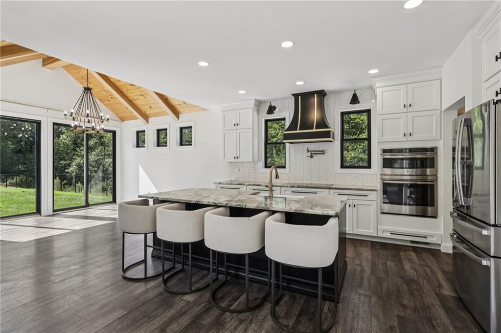 1565 Neville Road Beaver, PA 15009 - Photo 10 of 50 a kitchen with stainless steel appliances a dining table chairs and wooden floor