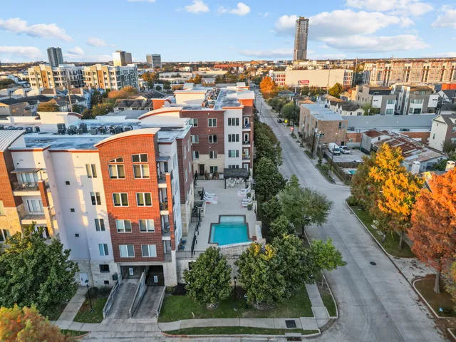 a aerial view of a residential apartment building with a yard