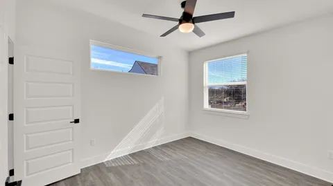 a view of empty room with wooden floor