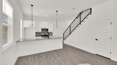 a view of kitchen with furniture and wooden floor