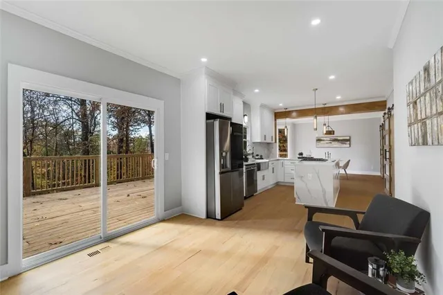 a kitchen with white cabinets and stainless steel appliances