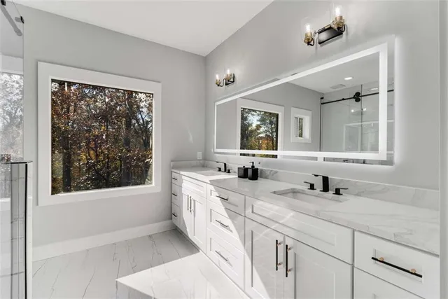 a bathroom with 2 sink and a mirror