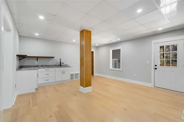 a kitchen with granite countertop white cabinets and stainless steel appliances