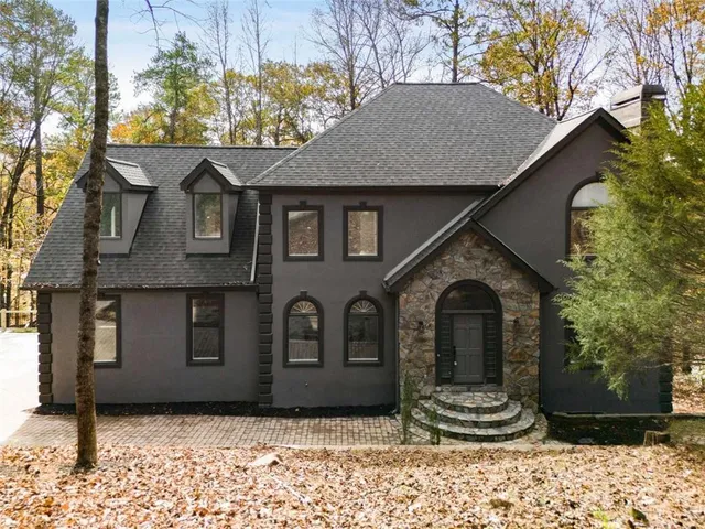a front view of a house with a yard