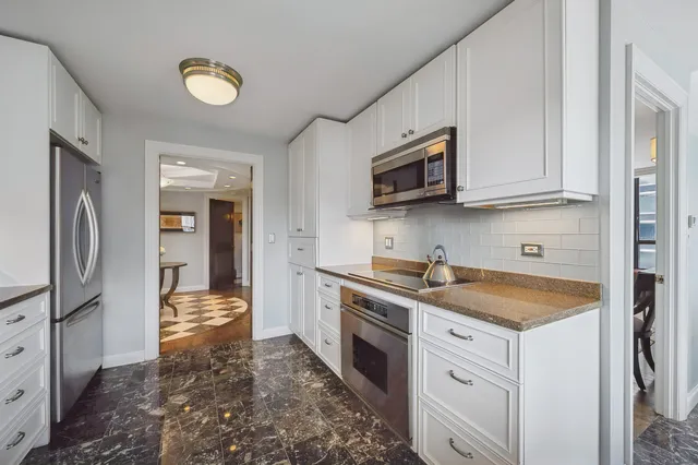 a kitchen with a sink stove and refrigerator