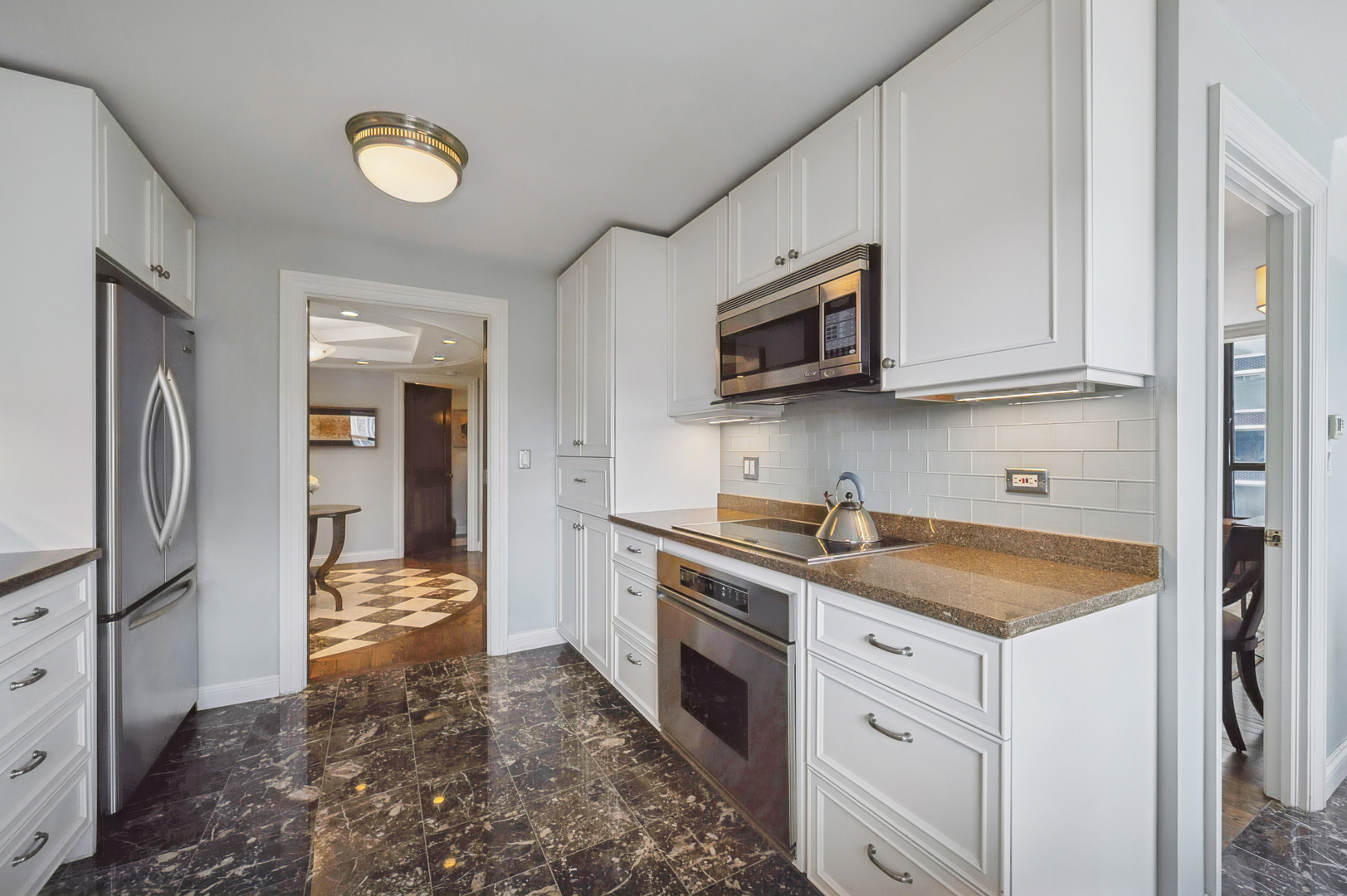 1313 North Ritchie Court, Unit 2701 Chicago, IL 60610 - Photo 12 of 33 a kitchen with a sink stove and refrigerator