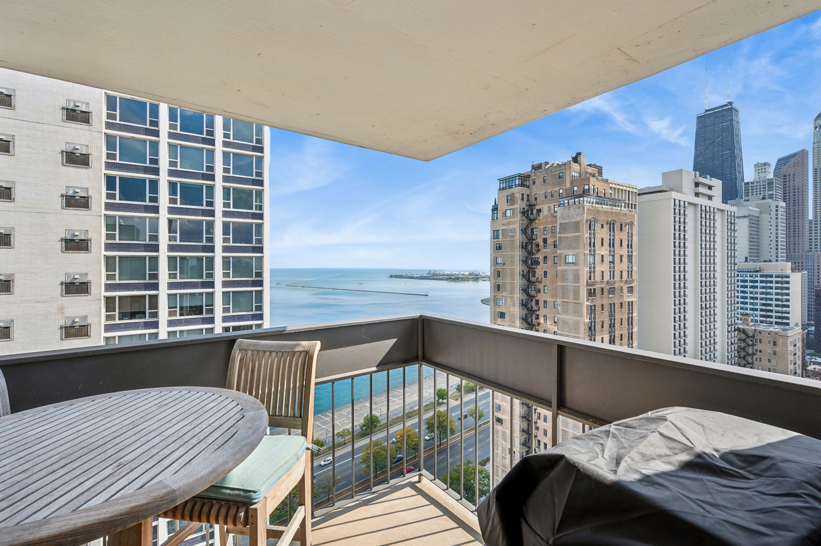1313 North Ritchie Court, Unit 2701 Chicago, IL 60610 - Photo 14 of 33 a view of a balcony with two chairs and a table