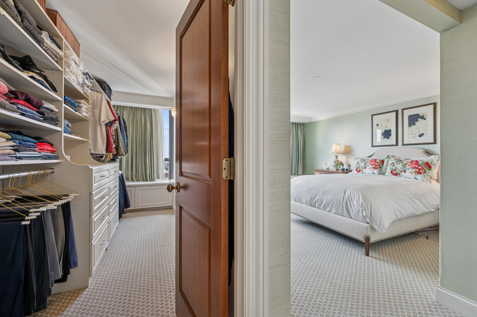 1313 North Ritchie Court, Unit 2701 Chicago, IL 60610 - Photo 19 of 33 a en suite spacious bedroom with a bed a mirror and a book shelf