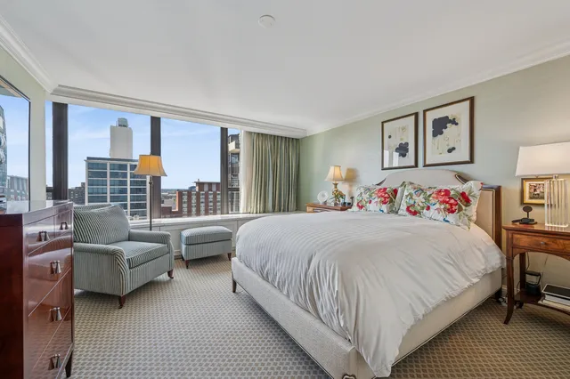 a bedroom with bed and a large window