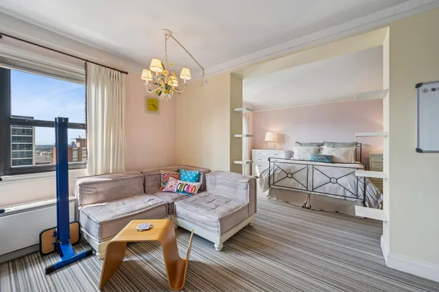 a living room with furniture and a chandelier