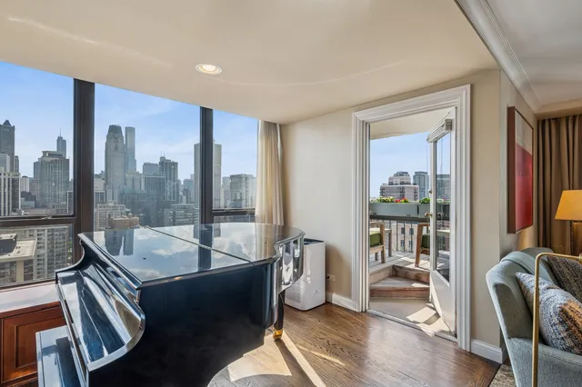 a living room with furniture and a floor to ceiling window