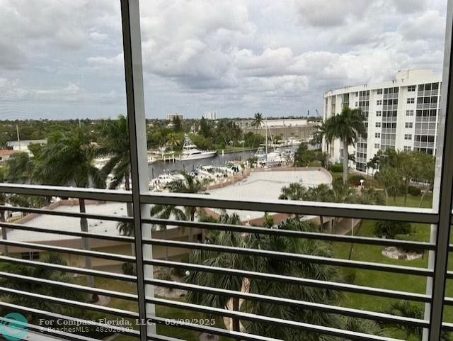 2731 Northeast 14th Street Causeway, Unit 612 Pompano Beach, FL 33062 - Photo 16 of 22 a view of a balcony with a floor to ceiling windows with wooden floor