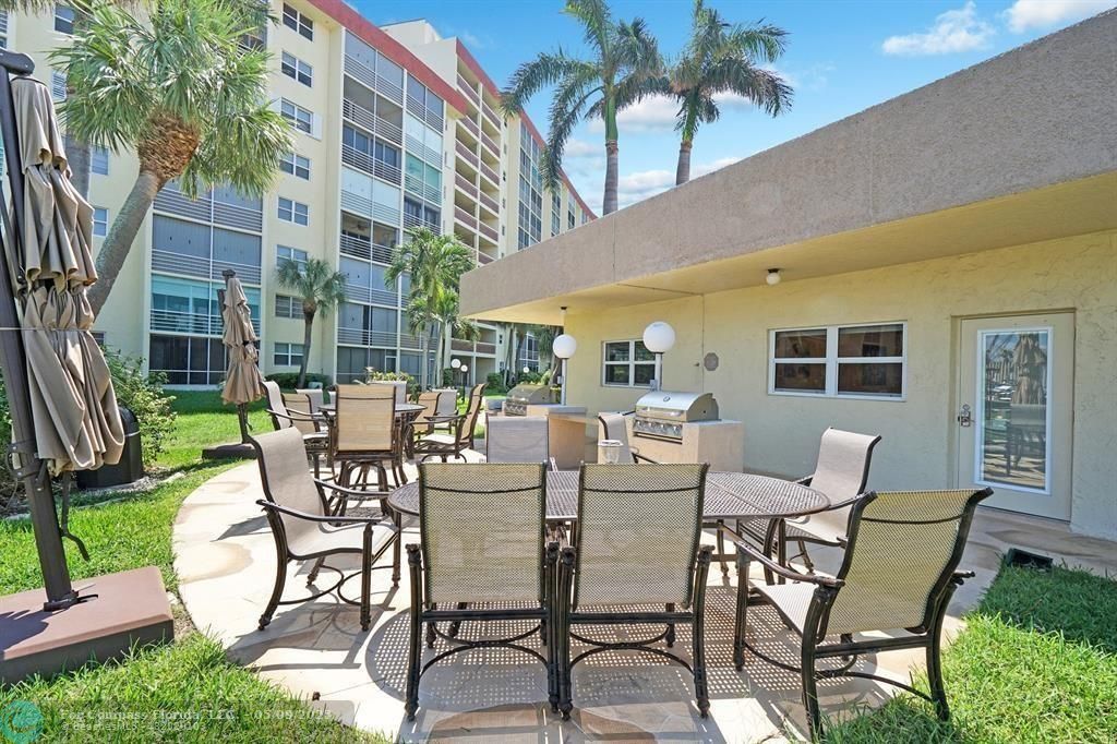 2731 Northeast 14th Street Causeway, Unit 612 Pompano Beach, FL 33062 - Photo 19 of 22 a dining area with a table and chairs