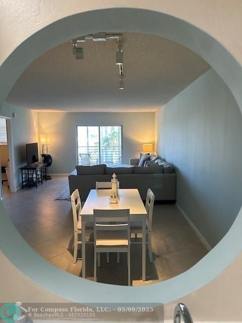 2731 Northeast 14th Street Causeway, Unit 612 Pompano Beach, FL 33062 - Photo 6 of 22 a living room with furniture and a flat screen tv