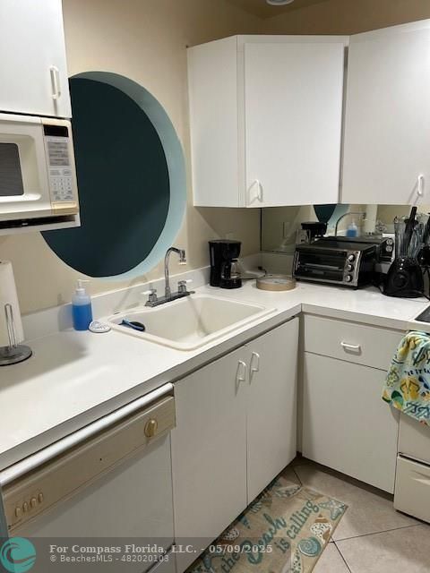 2731 Northeast 14th Street Causeway, Unit 612 Pompano Beach, FL 33062 - Photo 7 of 22 a kitchen with a sink and a stove