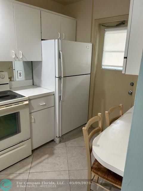 2731 Northeast 14th Street Causeway, Unit 612 Pompano Beach, FL 33062 - Photo 8 of 22 a kitchen with appliances and cabinets