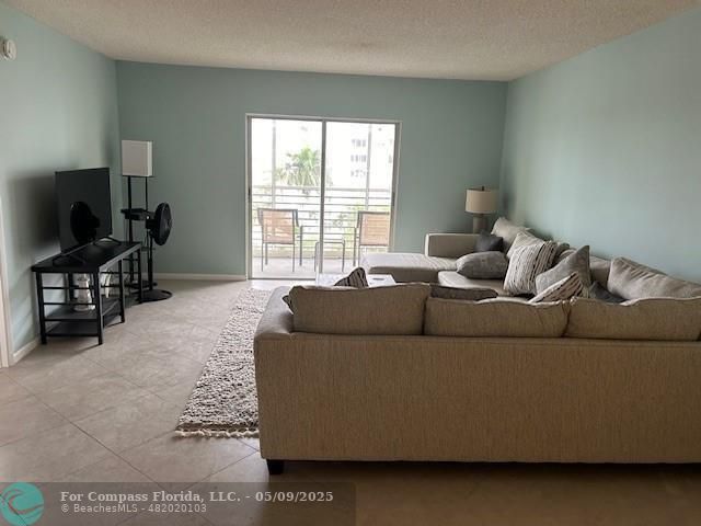 2731 Northeast 14th Street Causeway, Unit 612 Pompano Beach, FL 33062 - Photo 9 of 22 a living room with furniture and a flat screen tv