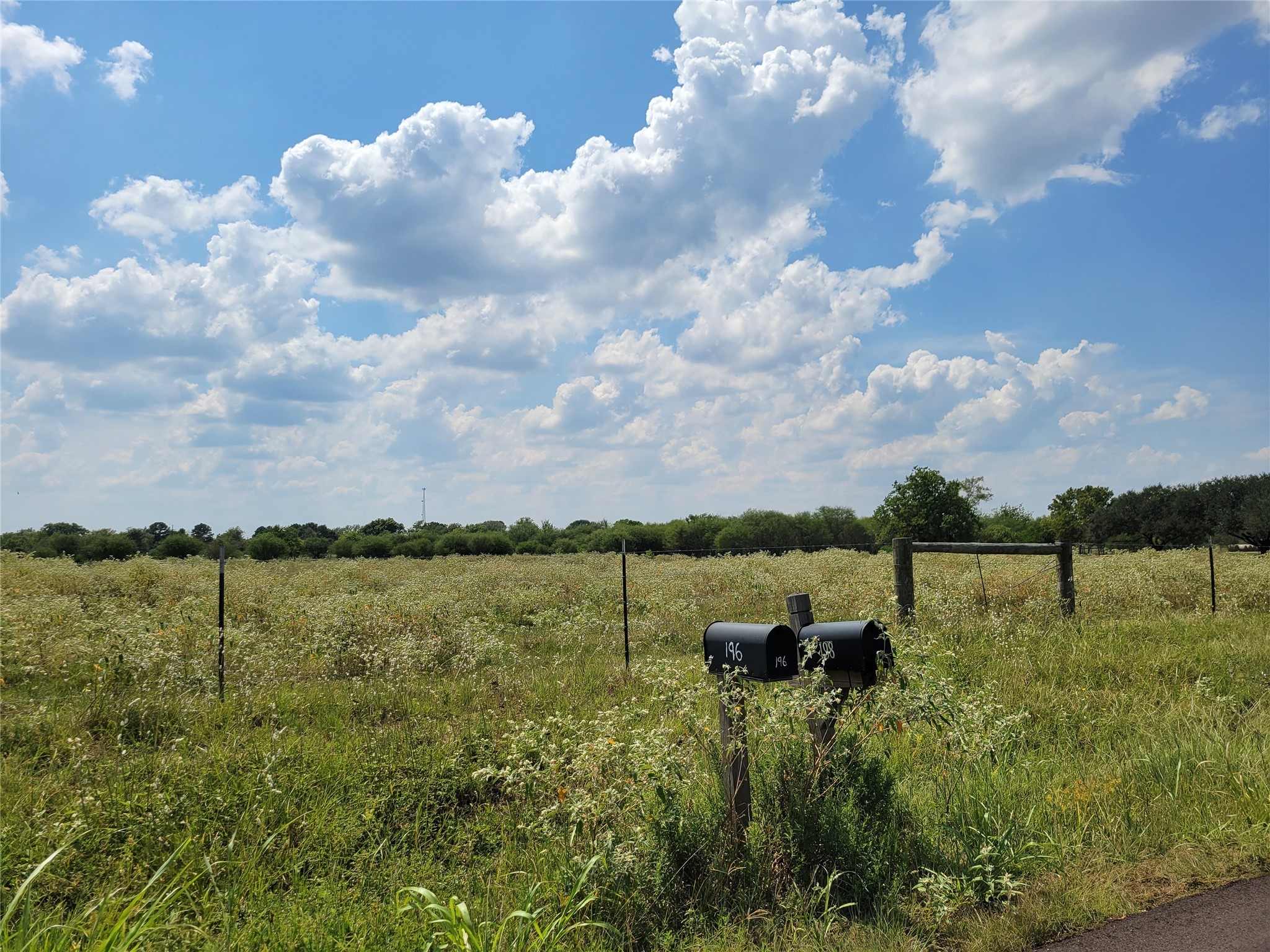 198 Langberg Road Bellville, TX 77418 - Photo 1 of 9 a view of a lake with houses in back