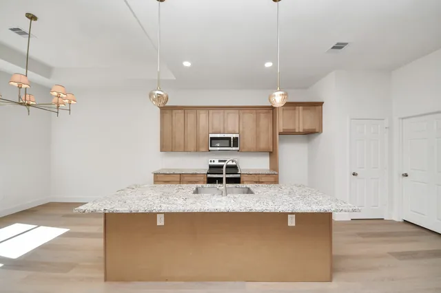 a bathroom with a granite countertop sink a large mirror and vanity