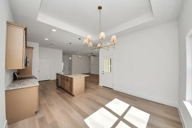 a bathroom with a granite countertop double vanity sink and a mirror