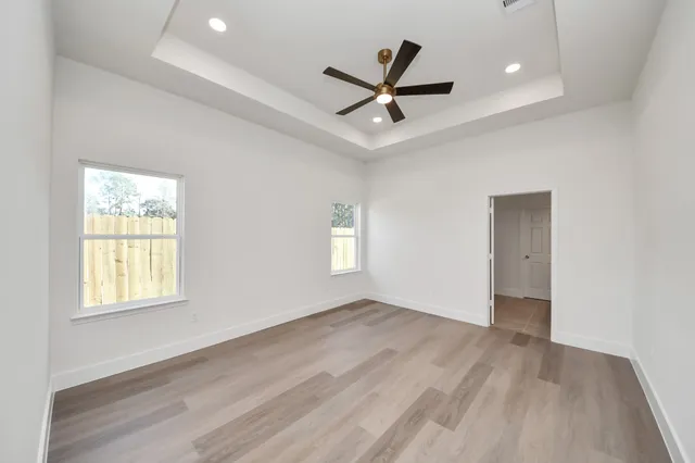 a spacious bathroom with a granite countertop sink and a mirror