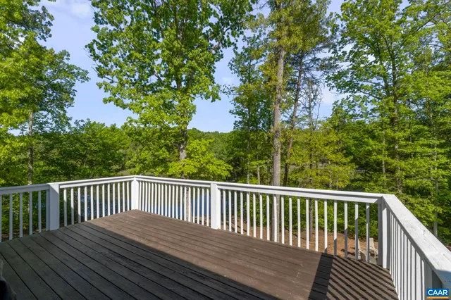 a living room with furniture a flat screen tv and a floor to ceiling window
