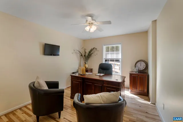 a bedroom with a large bed and wooden floor