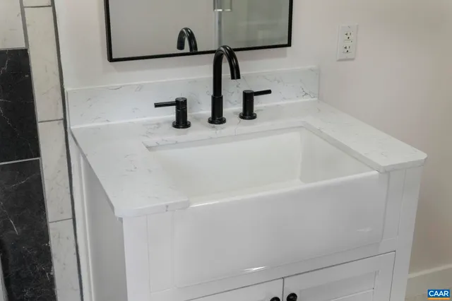 a view of a lake with a yard and large trees