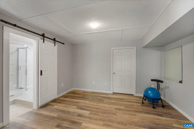 an aerial view of residential house with outdoor space and trees all around