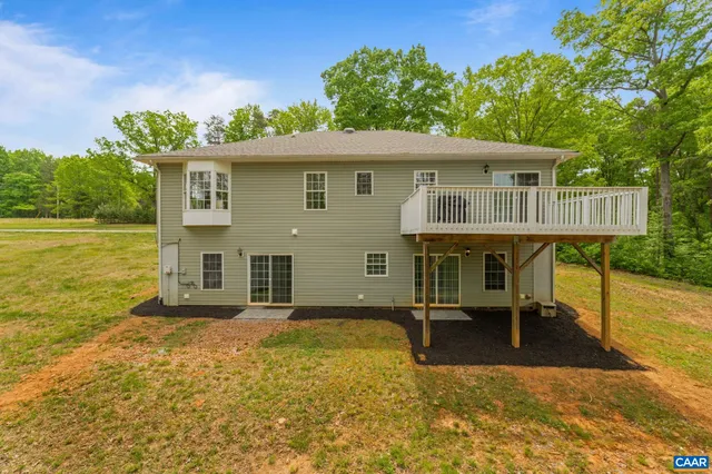a view of a hallway to a livingroom and a chair
