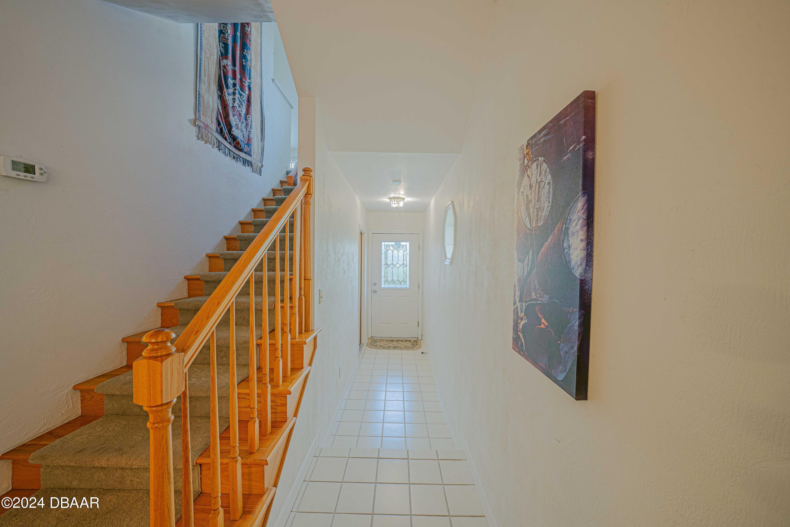 42 Jana Drive Ponce Inlet, FL 32127 - Photo 13 of 34 a view of a hallway with stairs