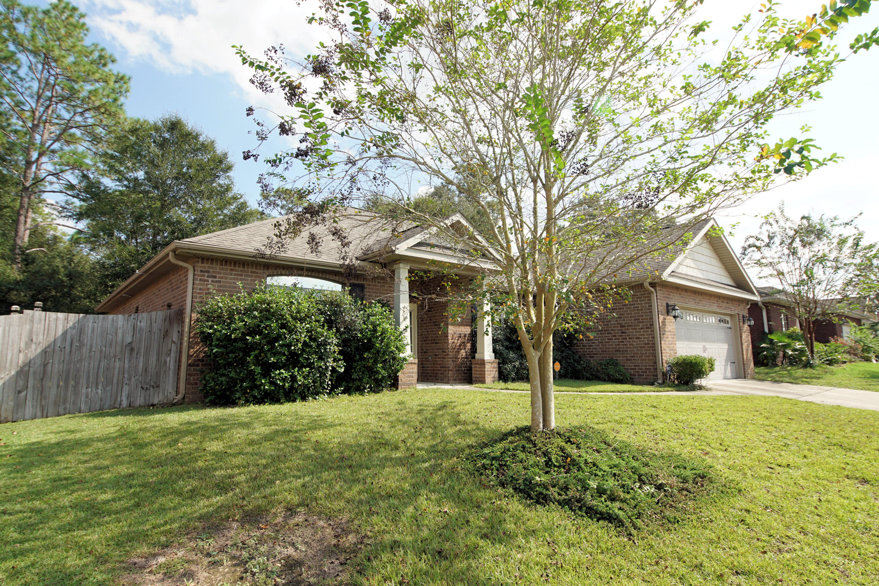 4628 Hermosa Road Crestview, FL 32539 - Photo 2 of 40 a view of a house with yard and a tree