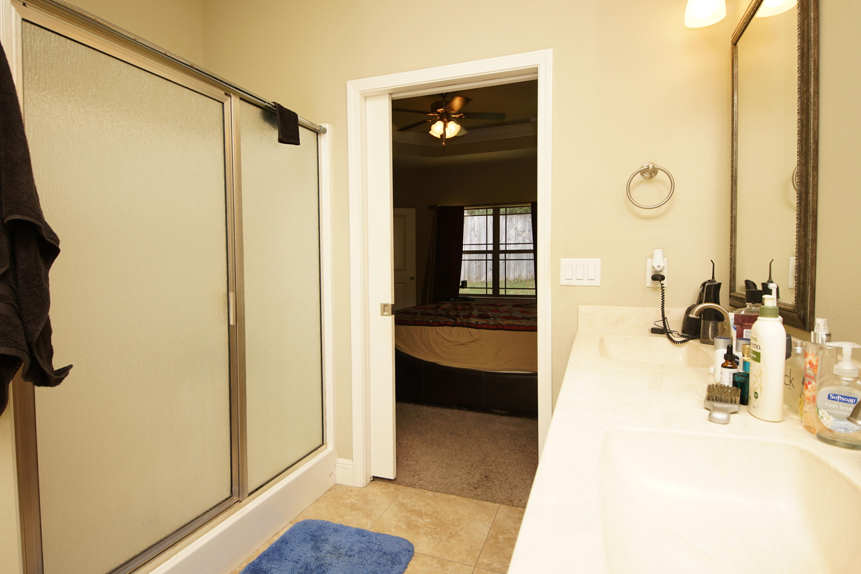 4628 Hermosa Road Crestview, FL 32539 - Photo 17 of 40 a bathroom with a tub shower and a sink